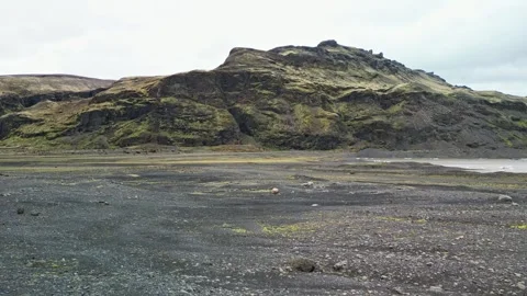 Drone flight over rugged moss covered volcanic hills Iceland 4K Video stock 344128659