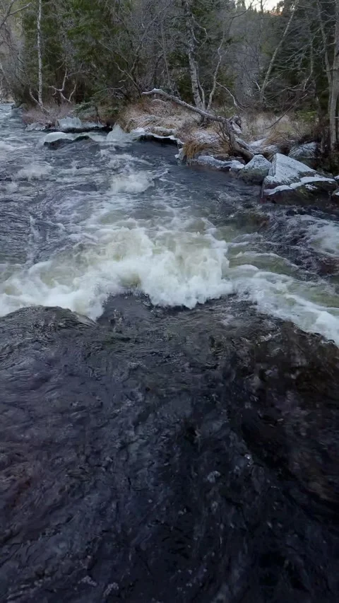 Drone flight over a rushing water creek, winter area. Stock-Footage 319501432