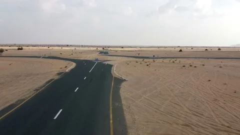 Drone flight over a sand-covered road Stock Footage 218122348