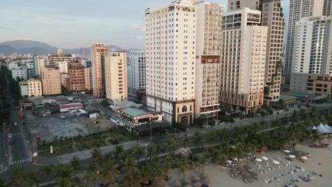 Drone flight over the sandy beach with the streets and hotels 2 Video stock 251984447