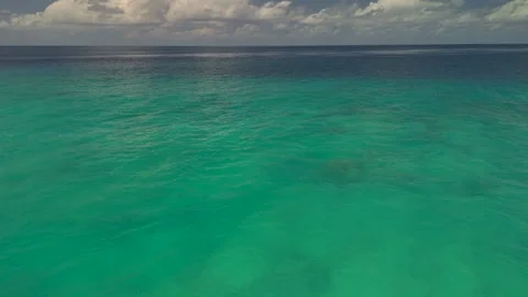 Drone flight over the sea. The endless horizon with white tropical clouds Stock Footage 322120877