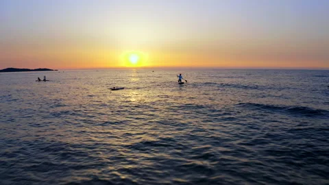Drone flight over sea, group of surfers welcome the sunrise. 4k Vídeos de archivo 156798714