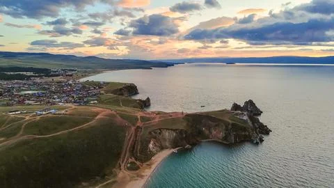 Drone flight over the shore of Lake Baikal at sunset Stock Photos