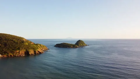Drone flight over a small deserted green island Stock Footage 323000105