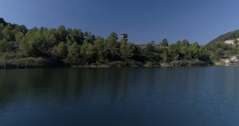 Drone flight over small lagoon in inland Stock Footage 93393494