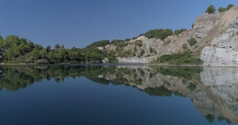 Drone flight over small lagoon in inland Stock Footage 93393651