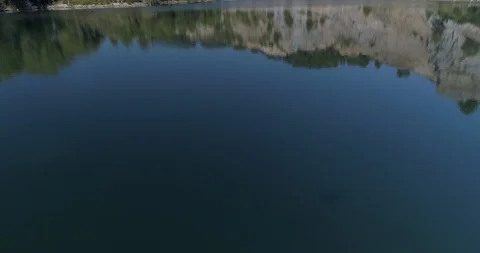 Drone flight over small lagoon in inland Stock Footage 93393851