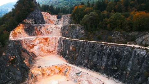 Drone flight over a small quarry in a mountainside forest with autumn colors Stock Footage 296582209