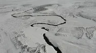 Drone Flight Over Small River Meandering Through Snow Covered Landscape Iceland Stock Footage