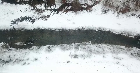 Drone Flight Over Small River Meandering Through Snow Covered Stock Footage 125038823