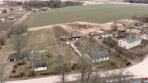 Drone flight over small rural vilage Umurga during spring time, Latvia 動画素材 152718464