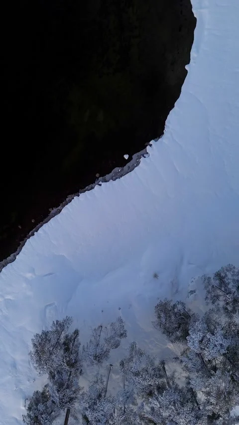 Drone flight over snow and blackwater lake. Norway Stock-Footage 319476902