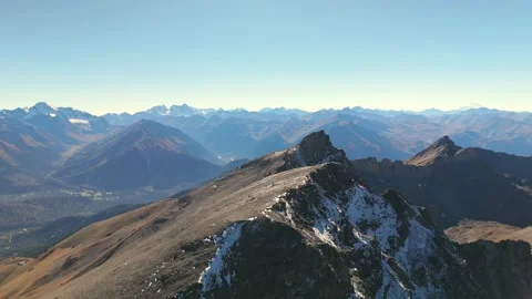 Drone flight over snowy alpine ridge and vast mountains Stock Footage 336022906