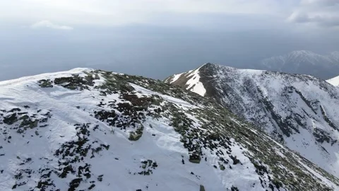 Drone flight over the snowy mountain in winter. peak and ridge view, alps 4k Stock Footage 152578417