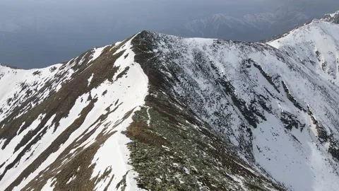 Drone flight over the snowy mountain in winter. peak and ridge view, alps 4k Stock Footage 152578436