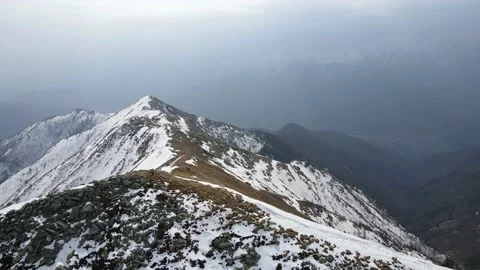 Drone flight over the snowy mountain in winter. peak and ridge view, alps 4k Stock Footage 152578439