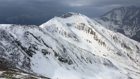 Drone flight over the snowy mountain in winter. peak and ridge view, alps 4k Stock Footage 152578469