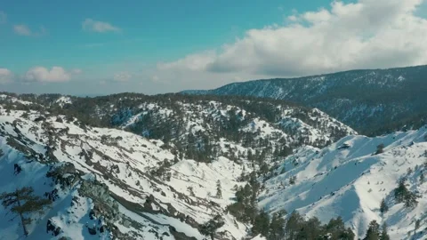 Drone flight over the snowy mountains Stock Footage 247963548