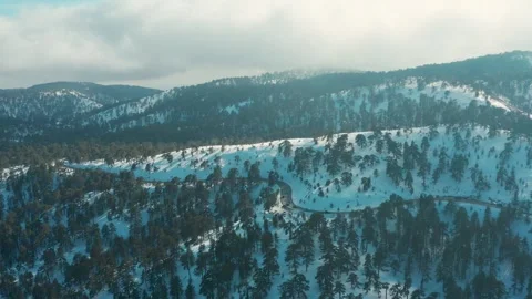 Drone flight over the snowy mountains of Troodos Stock Footage 248004473