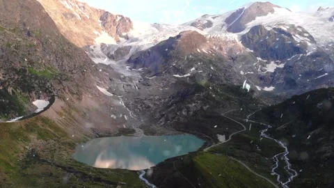 Drone Flight Over Snowy Mountains with Falling Snow Stock Footage 330278372