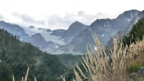 Drone Flight Over Snowy Mountains with Falling Snow Stock Footage 330278652