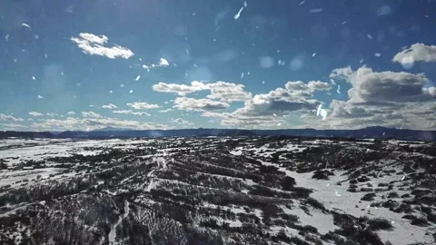 Drone Flight Over Snowy Mountains with Falling Snow Video stock 330279059