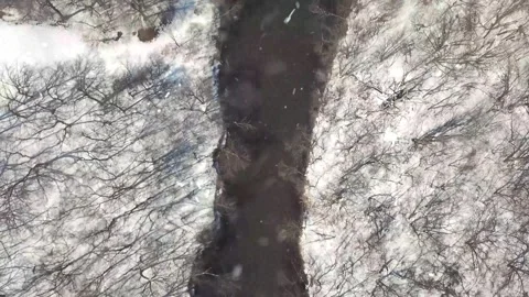 Drone Flight Over Snowy River Valley at Sunset with Falling Snow Stock Footage 330278440