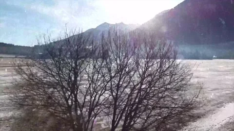 Drone Flight Over Snowy River Valley at Sunset with Falling Snow Stock Footage 330278938
