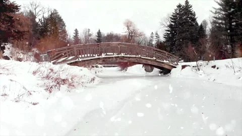 Drone Flight Over Snowy River Valley at Sunset with Falling Snow Stock Footage 330278948