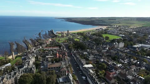 Drone flight over St Andrews, looking towards the Cathedral and beach 4K Stock Footage 219023197