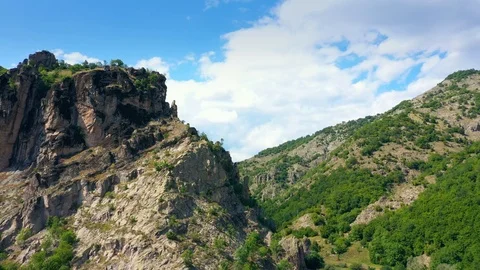 Drone flight over steep hill towards the summer mountains.  Video stock 114413208
