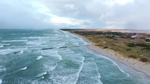 Drone Flight Over Stormy Baltic Sea Coast With Old Pier And Pape Lighthouse Stock Footage 327522483