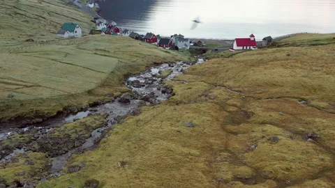 Drone Flight Over Stream Leading Village Of Arnafjordur Video stock 134284230