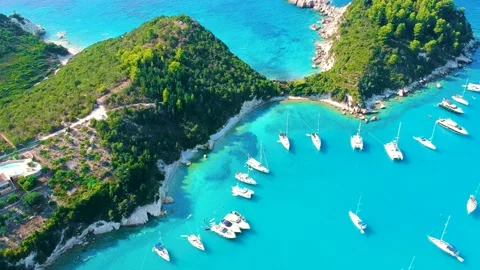 Drone flight over stunning tropical waters, boats and lush green cliff forests Stock Footage 234340934