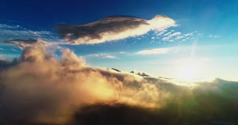 Drone Flight Over Sunlit Clouds Among Snowy Mountain Peaks Stock Footage 330926210