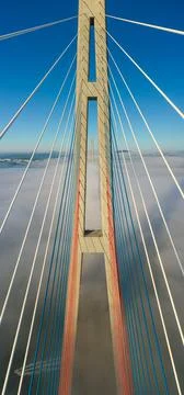 Drone flight over the support of the bridge built across the sea strait at dawn Foto stock