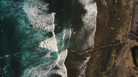 Drone flight over surfers waiting for good waves on Tenerife beach. Canary Stock-Footage 228967937