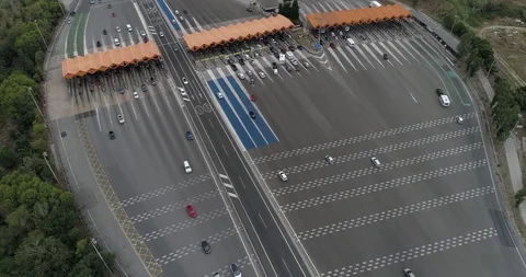 Drone flight over toll with orange booths in  highway Stock Footage 94530505