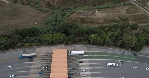 Drone flight over toll with orange booths in  highway Stock Footage 94530717