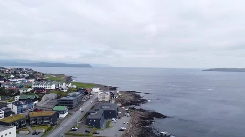 Drone flight over Torshavn harbor with ships and colorful coastal buildings Stock Footage 340167280