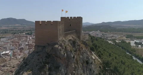 Drone flight over the tower of a medieval castle over village Stock Footage 209998124