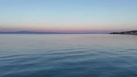 Drone Flight Over Tranquil Waters: Pink Sunset in Halkidiki Stock Footage 288589611