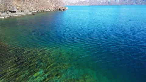 Drone Flight over Transparent Emerald Lake Water Vídeo Stock 336811840