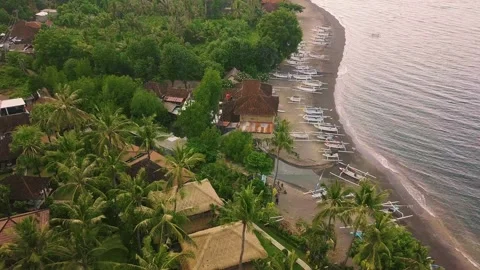 Drone flight over tropical beach resort with view of villas, boats and greenery. Video stock 137452787