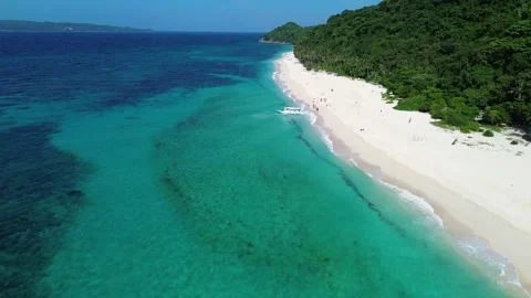 Drone flight over tropical Puka Beach coastline Boracay island clear blue oc Stock Footage 334050105