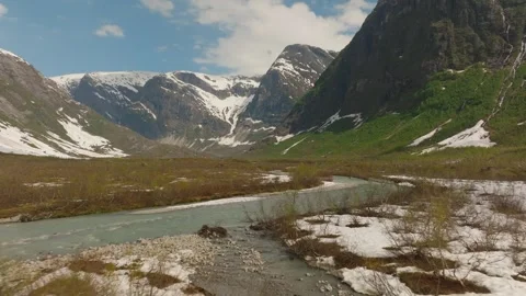 Drone Flight Over Turquoise Glacier River surrounded by Granite Peaks in Remote Vídeos de archivo 334804949