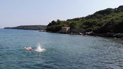 Drone flight over two people swimming in the sea. Croatia Stock Footage 112333442
