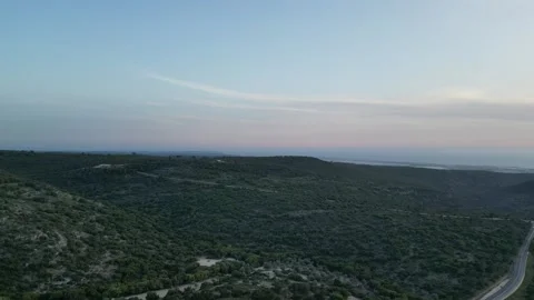 Drone Flight over the Valley with a View of the Sea in the Distance Stock Footage 240182398