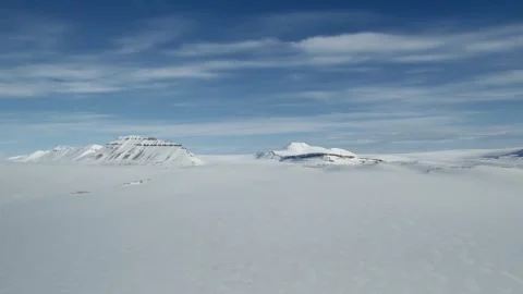 Drone flight over vast snow covered Arctic landscape in Svalbard, Norway Stock Footage 336558405