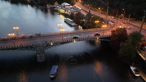 Drone flight over the Vltava river and bridges with lanterns and car traffic Stock Footage 256161499
